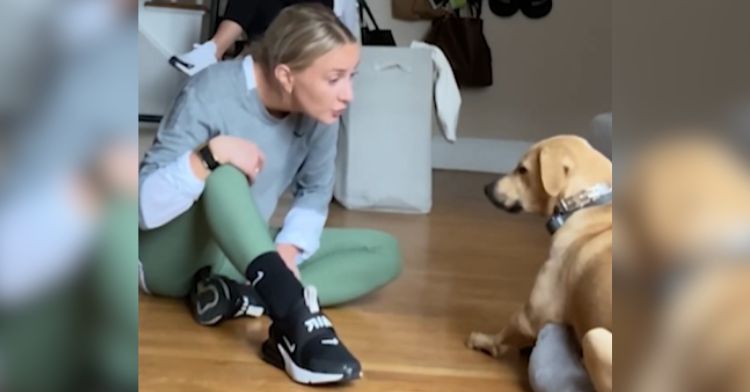 A woman teaches her dog to say, "I love you."