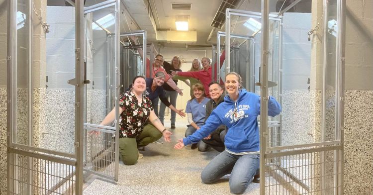 Animal shelter workers smile as their kennels are finally empty.