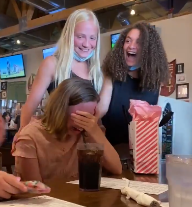 A girl bursts into happy tears when her friends from camp surprise her. 