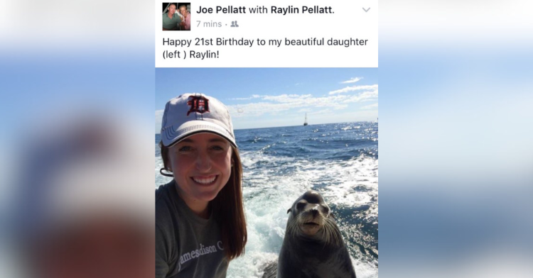 post of a woman posing next to a sea lion