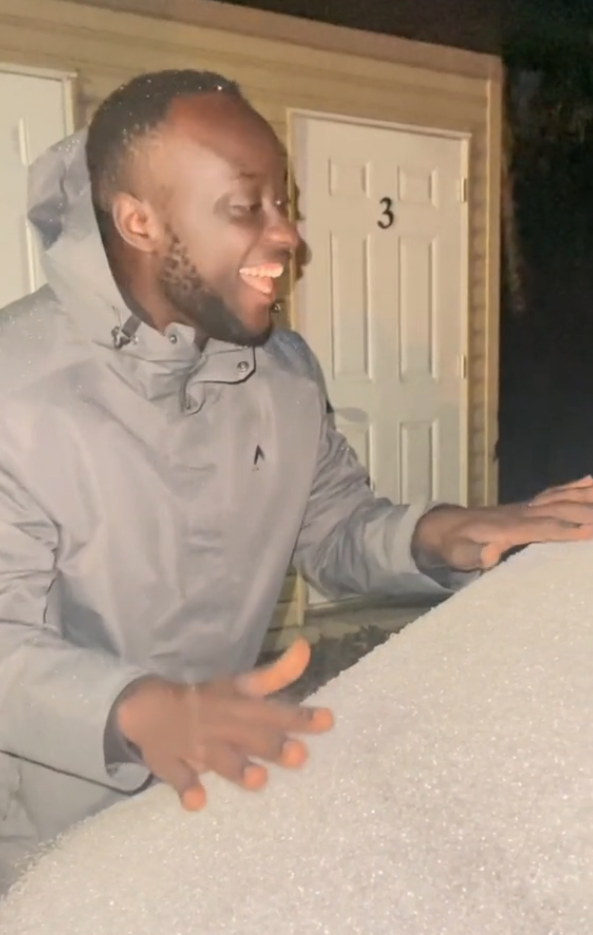 Ugandan man seeing snow for the first time.