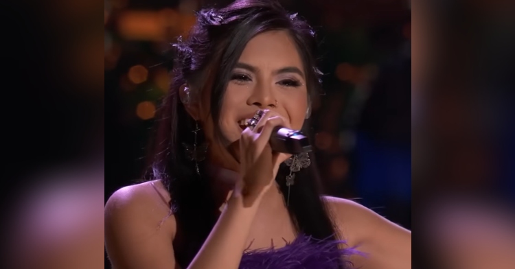 Close up of Kaylee Shimizu smiling as she sings, taking on "The Voice" Playoffs.