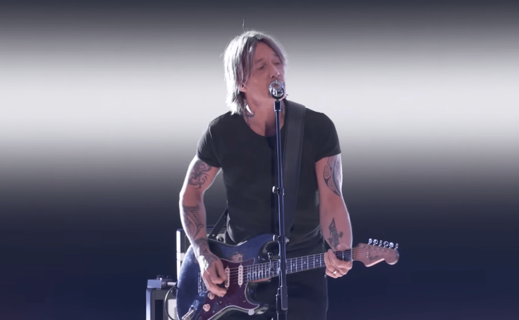 Keith Urban sings and plays electric guitar on the U.S. version of "The Voice."