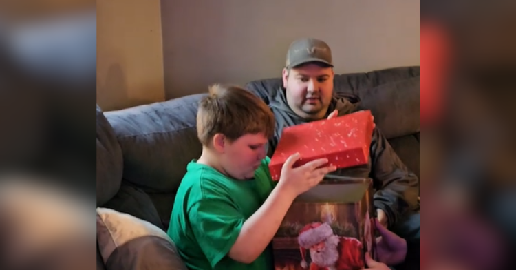 kid opening christmas box