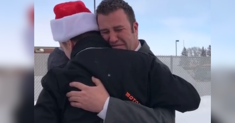 man hugging guy in santa hat