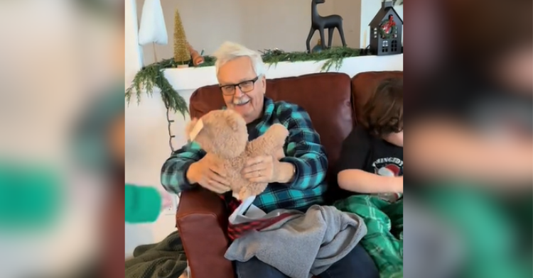 man hugging teddy bear