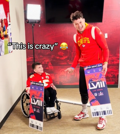 Isaac Murdock looks up at Patrick Mahomes who is smiling wide at the camera. Text on the image shows what Isaac is saying: "This is crazy."