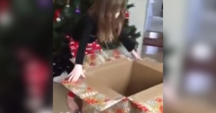 A little girl opens her Christmas gift only to find nothing inside.