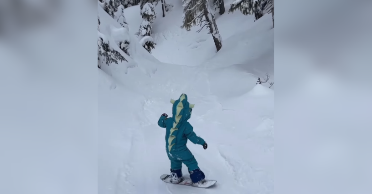 Little girl snowboarding
