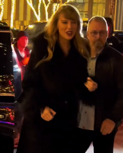 Taylor Swift smiles as she heads over to a little girl to take a photo together.