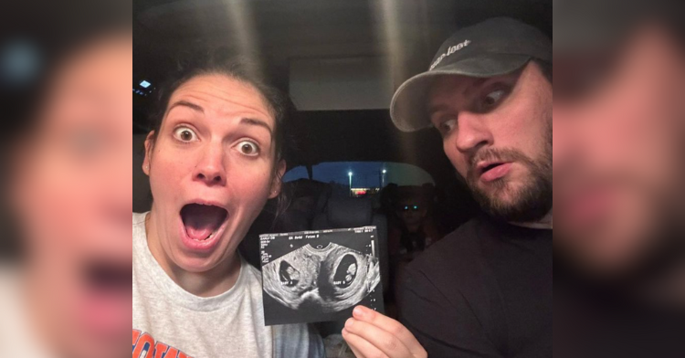 Woman pregnant with two uteruses holds up a sonogram