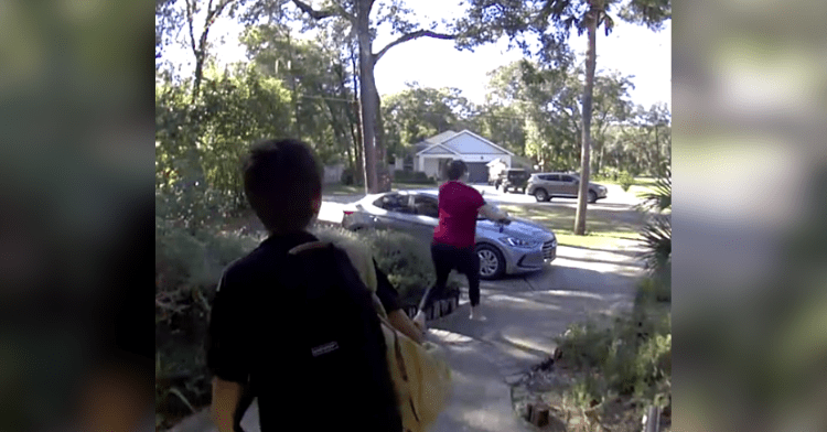 woman running to car with boy watching
