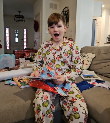A 10-year-old author receives a copy of his published book for Christmas. 