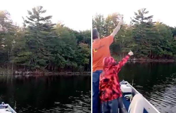 people holding up fish