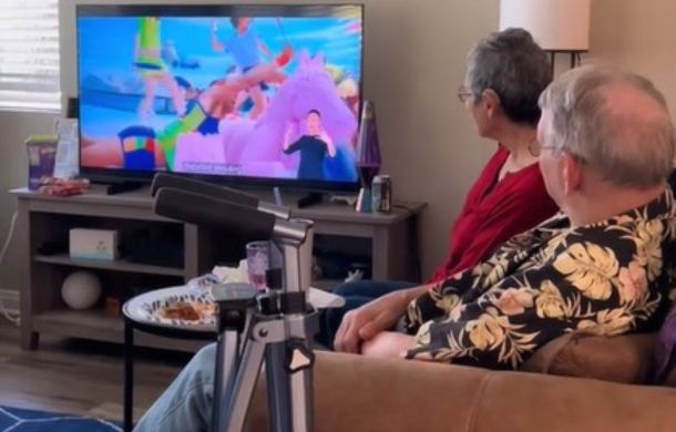 Two deaf people watching the new release of the "Barbie" movie with ASL interpretation.