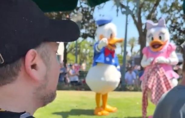 Disney's Donald Duck noticing voice actor Daniel Ross visiting to celebrate the famous duck's 90th birthday.