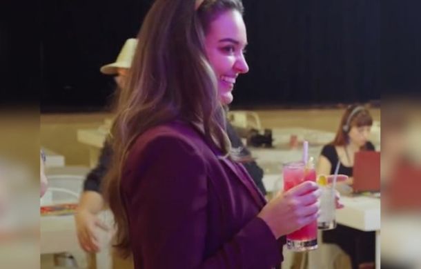Patron taking he human and AI drinks for the taste test.