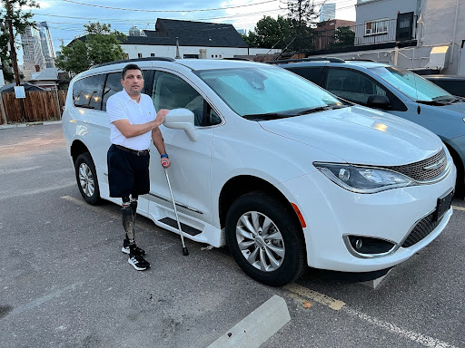 Muataz Azooz standing next to the van he received from MagicMobility Vans.