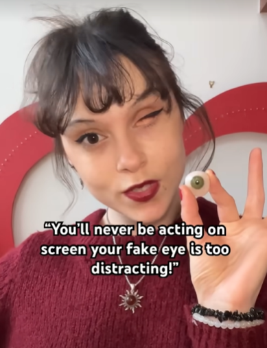 Young actress Kelsey Ellison holds up her prosthetic eye.