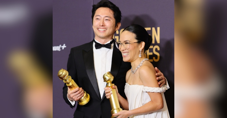 Steven Yeun and Ali Wong smile as they pose together on the Golden Globes red carpet, awards for best actor and actress in a limited series in their hands.