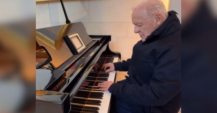 Actor Anthony Hopkins plays the piano in a hotel lobby.