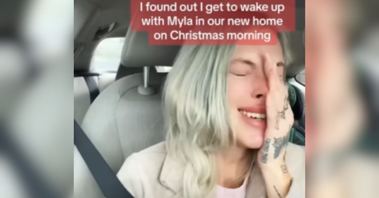 A single mom cries over a sweet coparenting moment in her car.