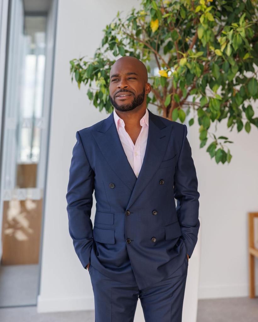 CEO Dean Forbes standing in a double-breasted suit. 