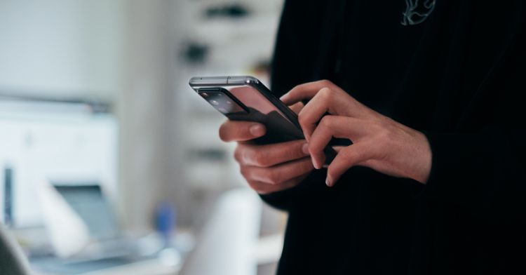 A man in need of a digital detox using his smartphone.