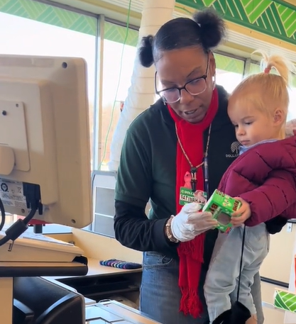 A Dollar Tree cashier picked up a cranky toddler and entertained her.