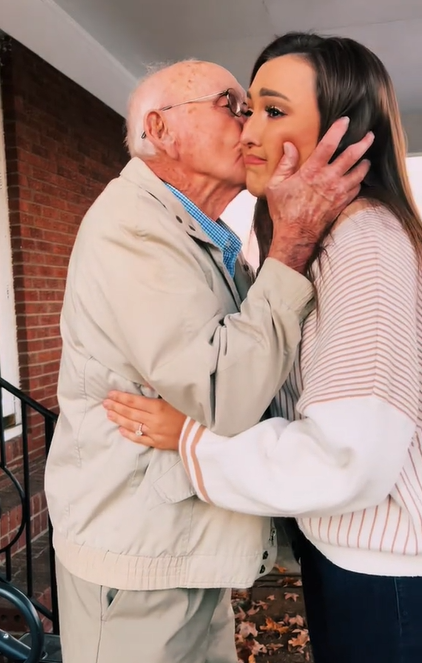 Image showing Papa's engagement reaction. He's holding Hayley Anderson's face as he kisses her cheek. Haley looks on the verge of tears.