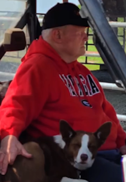 Donald Adams sits outside with his dog, Skippy, by his side.