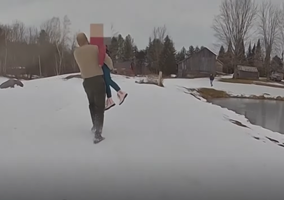 A state trooper helps rescue a little girl from a frozen pond.