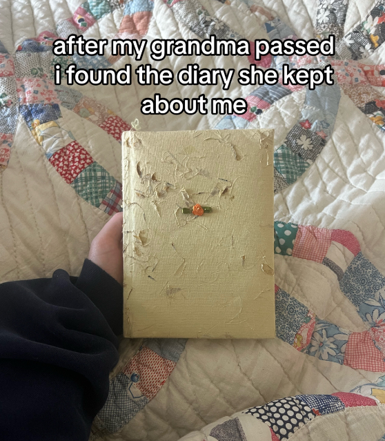 A girl holds her grandma's old diary. 
