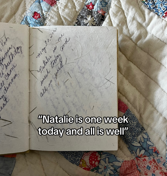 A handwritten diary laid open over a quilt.
