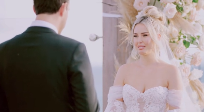 A two-photo collage. The first shows a groom talking into a mic as he gives his vows. Standing just behind him is the officiant, holding back tears. The second photo shows a bride who looks emotional as she holds back tears.