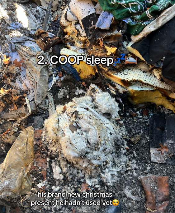 View of the aftermath of a home that burned down. There's lots of burned items on the ground.
Text on the image reads: COOP sleep. His brand new Christmas present he hadn't used yet
