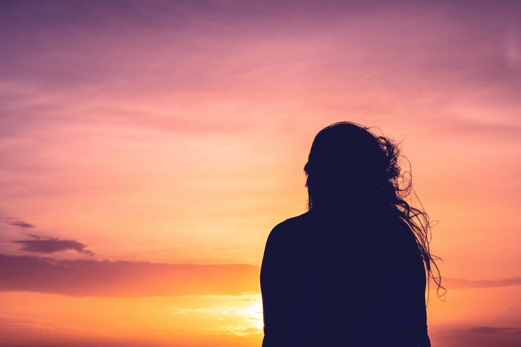 A woman's silhouette against a life-changing sunset.