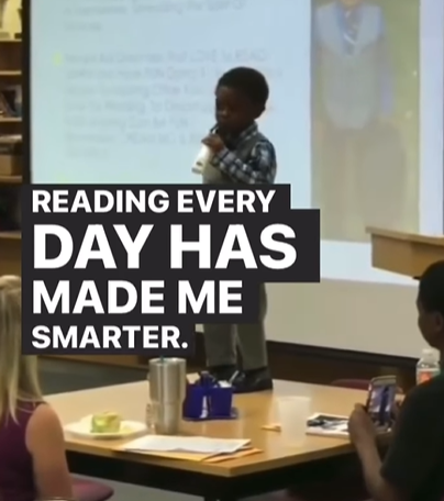 A little boy gives a speech about the importance of reading.