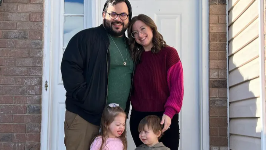Bridgette Ponson and her husband smile as they pose outside a front door with their two toddlers who are also smiling.