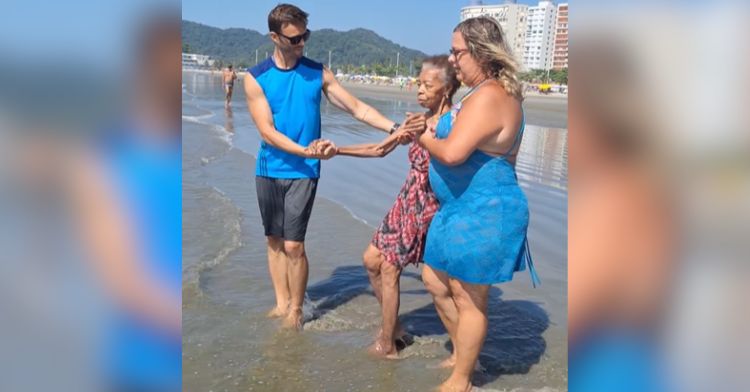 Nursing home volunteers take a resident to the beach.