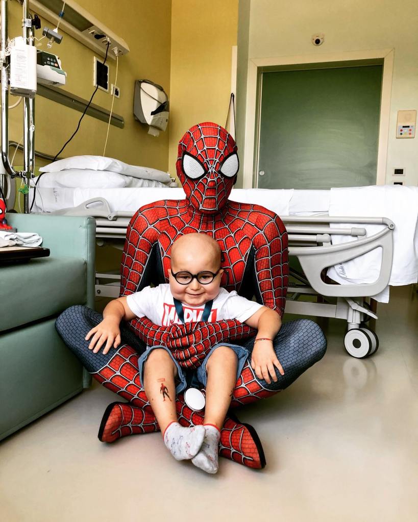 Spiderman visits a boy with leukemia in the hospital. 
