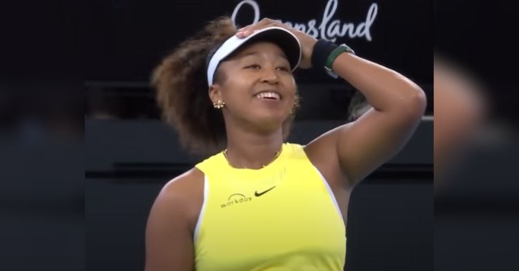 Naomi Osaka smiles after winning a tennis match.