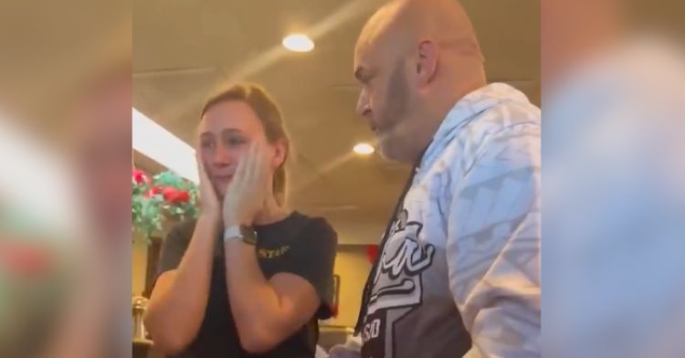 A pregnant waitress cries after receiving a generous tip.