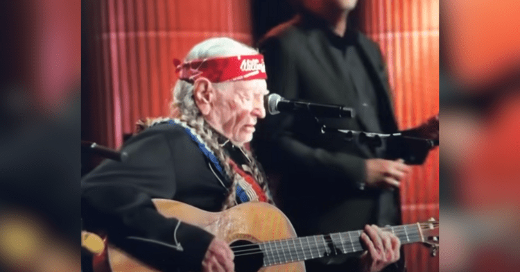 willie nelson playing guitar