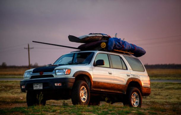 Stock image of an SUV loaded for a family trip. SUVs have become the current mom car.