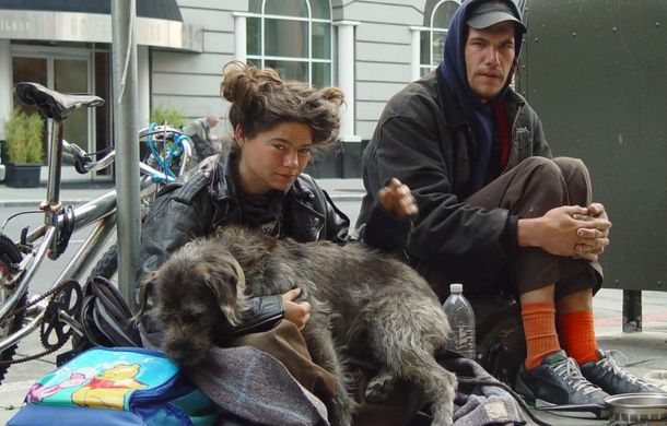 Homeless people with a pet dog. Current pet laws in California allow many rentals to prohibit pets, which makes it difficult for pet owners to find housing.