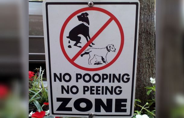 Sign discouraging pet owners from allowing their pets to relieve themselves.