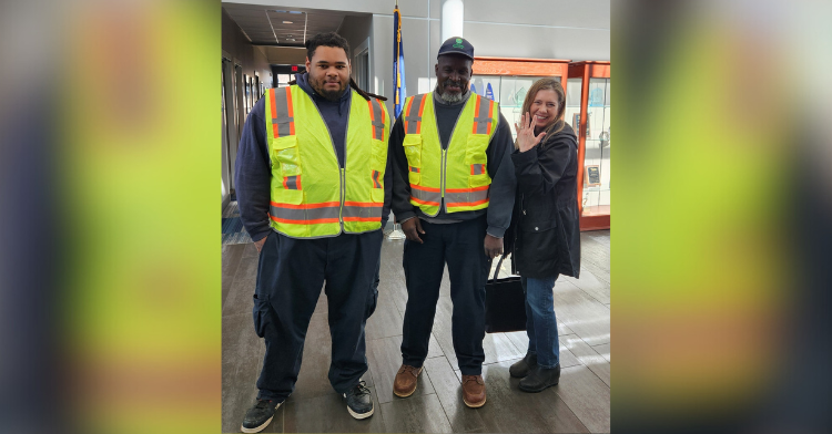 recycling center workers standing with woman whose ring they found