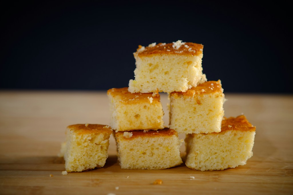 Pieces of cornbread stacked together in a triangle. 