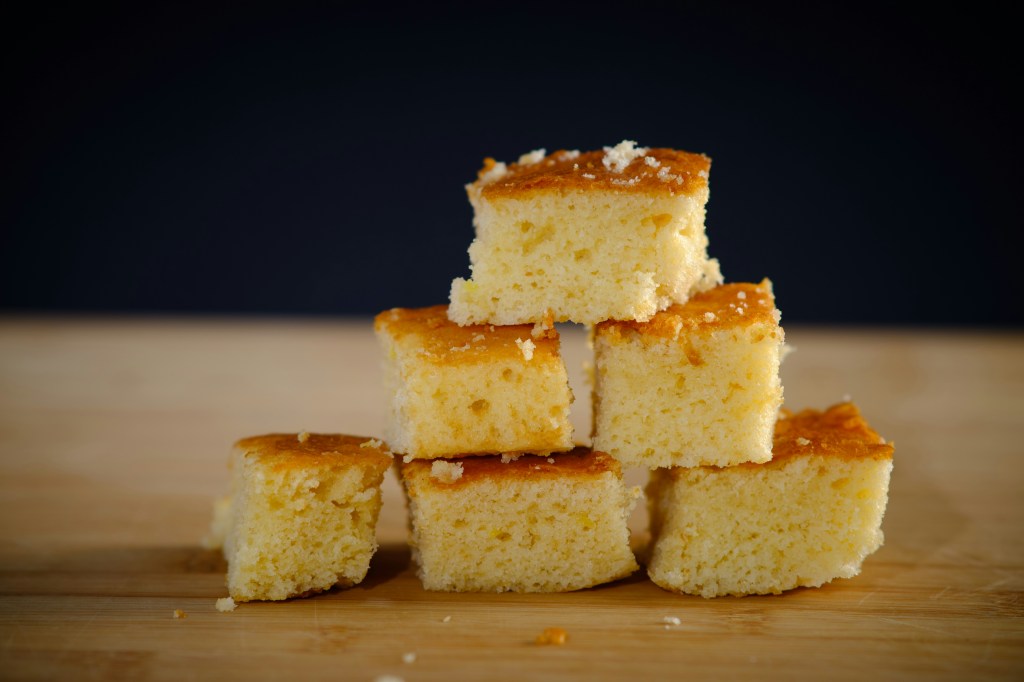 Pieces of cornbread stacked together in a triangle.